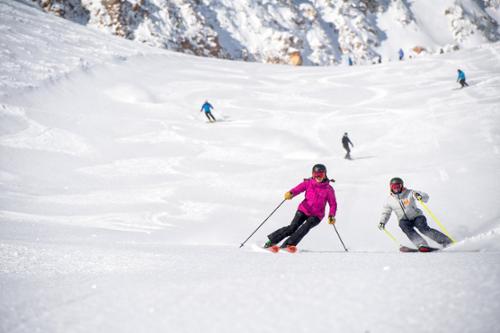Ski testers Krista Crabtree and Nick Loomans ski in unison in Mineral Basin at Snowbird, Utah.