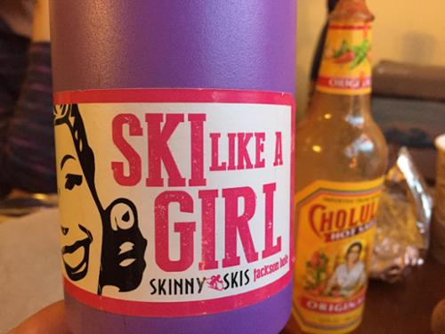 A bottle has a lable that says, "Ski like a Girl."